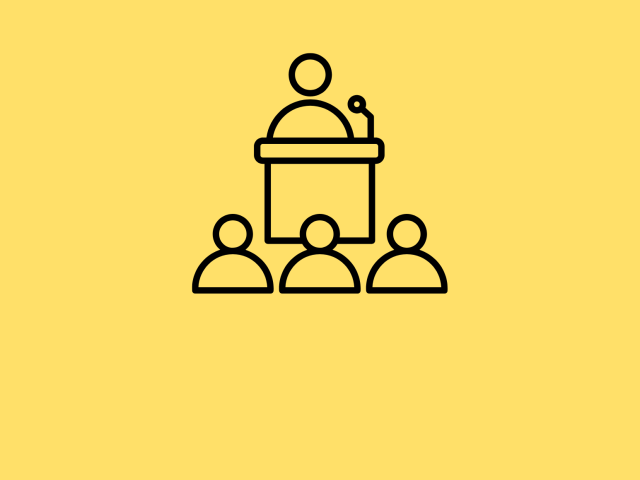 One stick figure at a podium speaking to an audience against a yellow background.