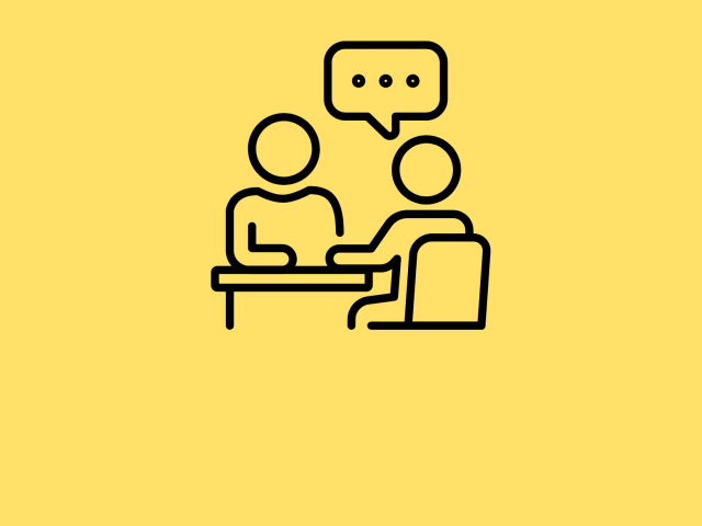 One stick figure behind a desk talking to another stick figure with a dialogue bubble above them against a yellow background.